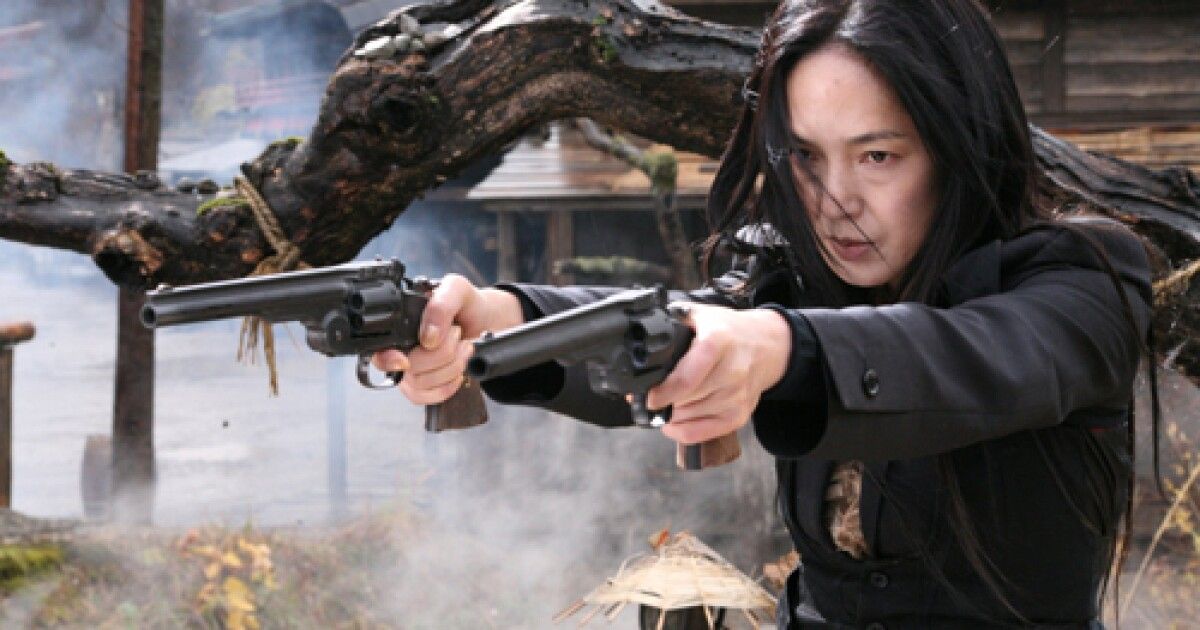 an actress aims two guns in Sukiyaki Western Django