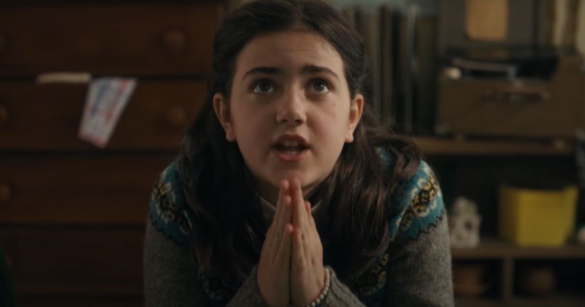 A girl prays on the floor in Are You God?  I'm Margaret