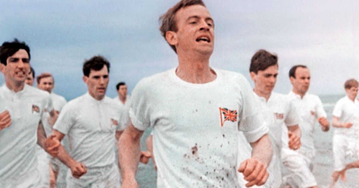 group-of-british-men-in-white-shirts-running-on-the-beach