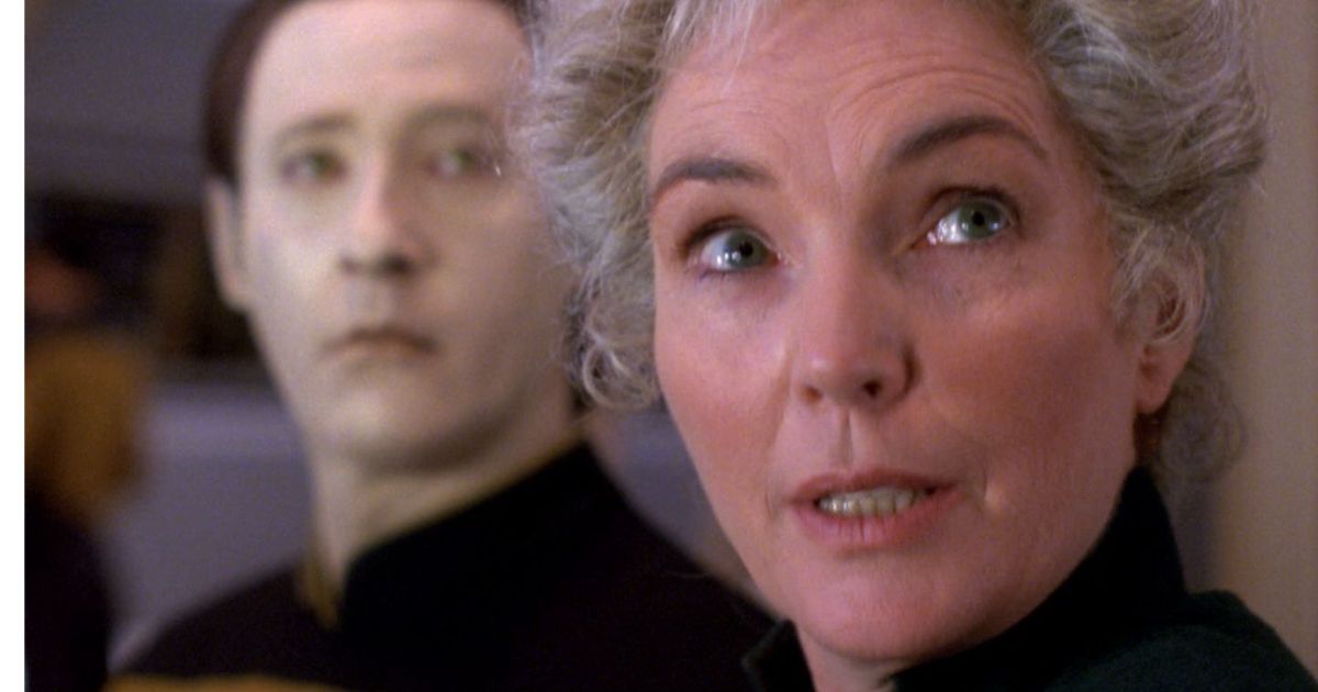 Data's mother in Star Trek looks severe. Data looks at her in the background. 