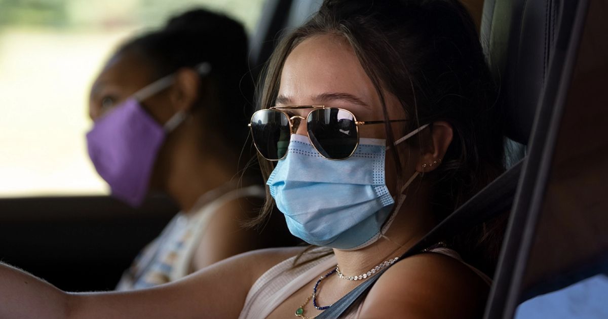 Gideon Adlon as Parker with Mimi wearing Covid masks in the Peacock horror movie Sick 2023