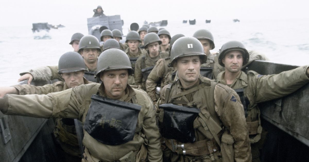 A group of military personnel await their boat to arrive to the shore in the film Saving Private Ryan