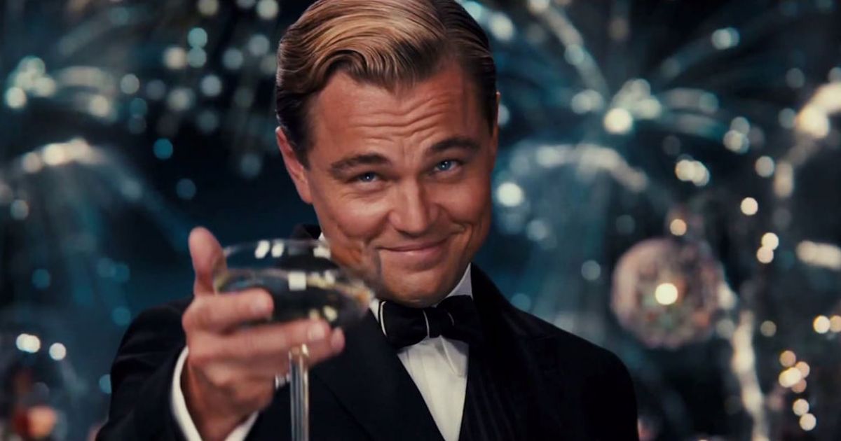 Leonardo DiCaprio toasting a drink in the movie Great Gatsby