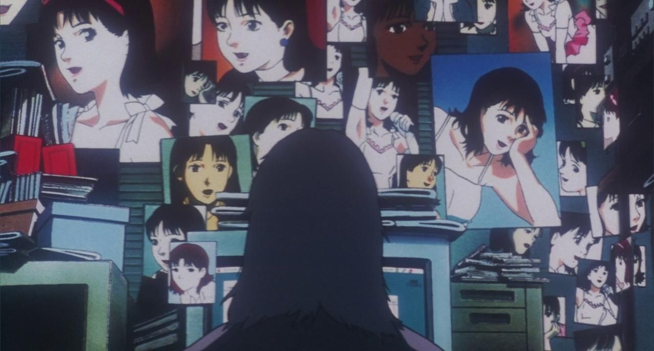 Perfect Blue: An unknown person sitting in front of many glowing monitors that show images of Mima