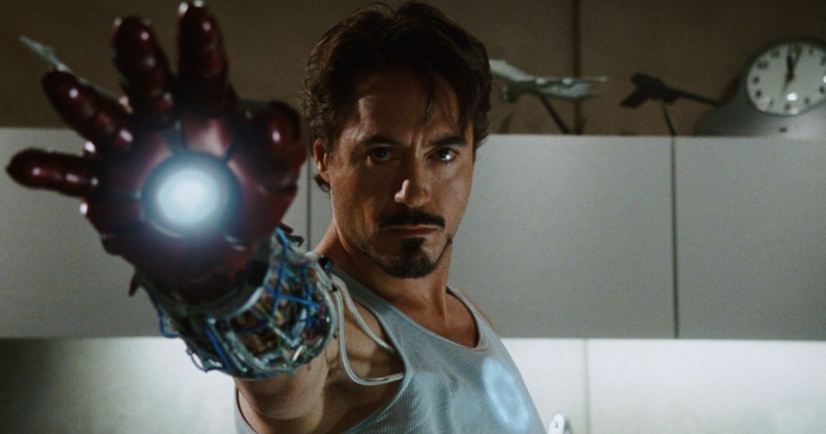 Robery Downey Jr. as Tony Stark with a single Iron Man gauntlet on