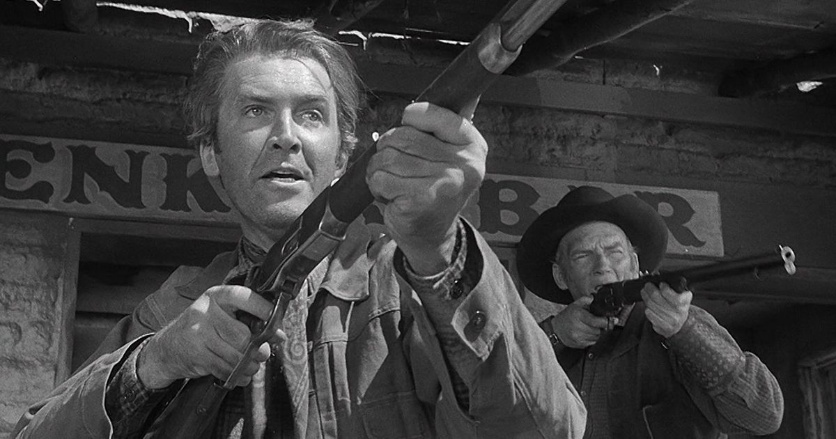 Jimmy Stewart holds a gun in the western Winchester 73