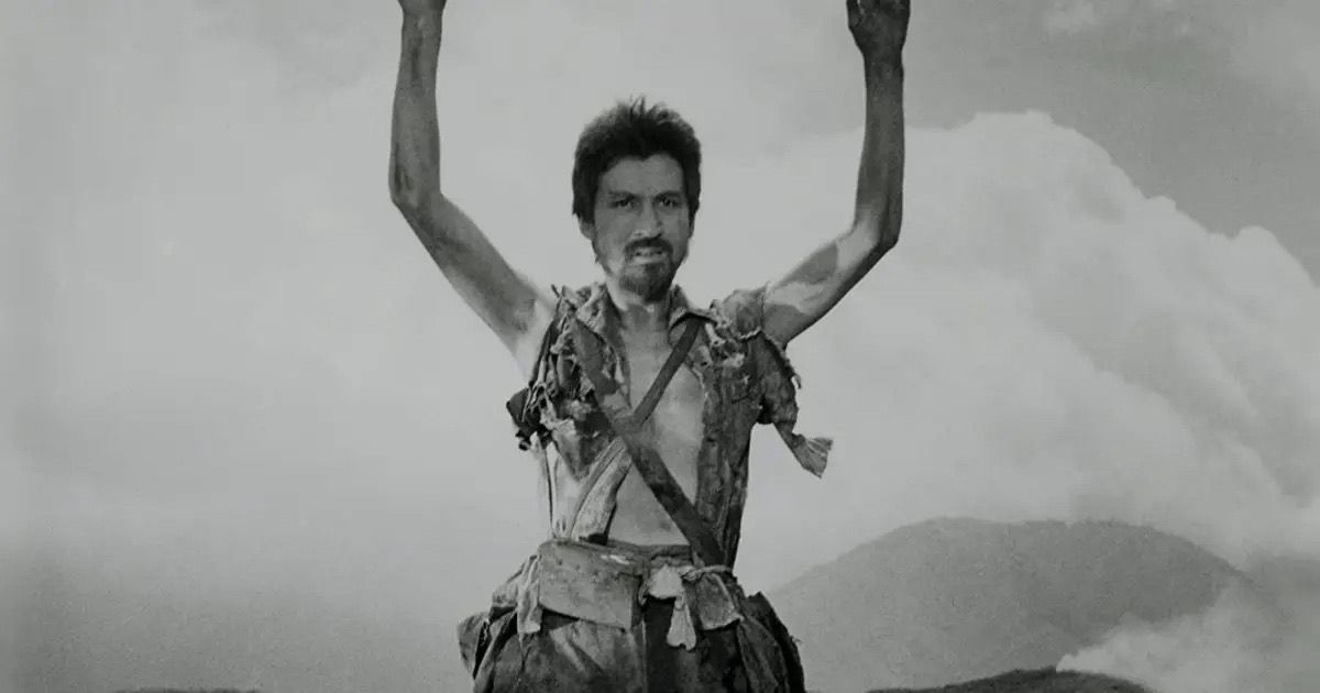 A soldier holds up his hands in Fires on the Plain