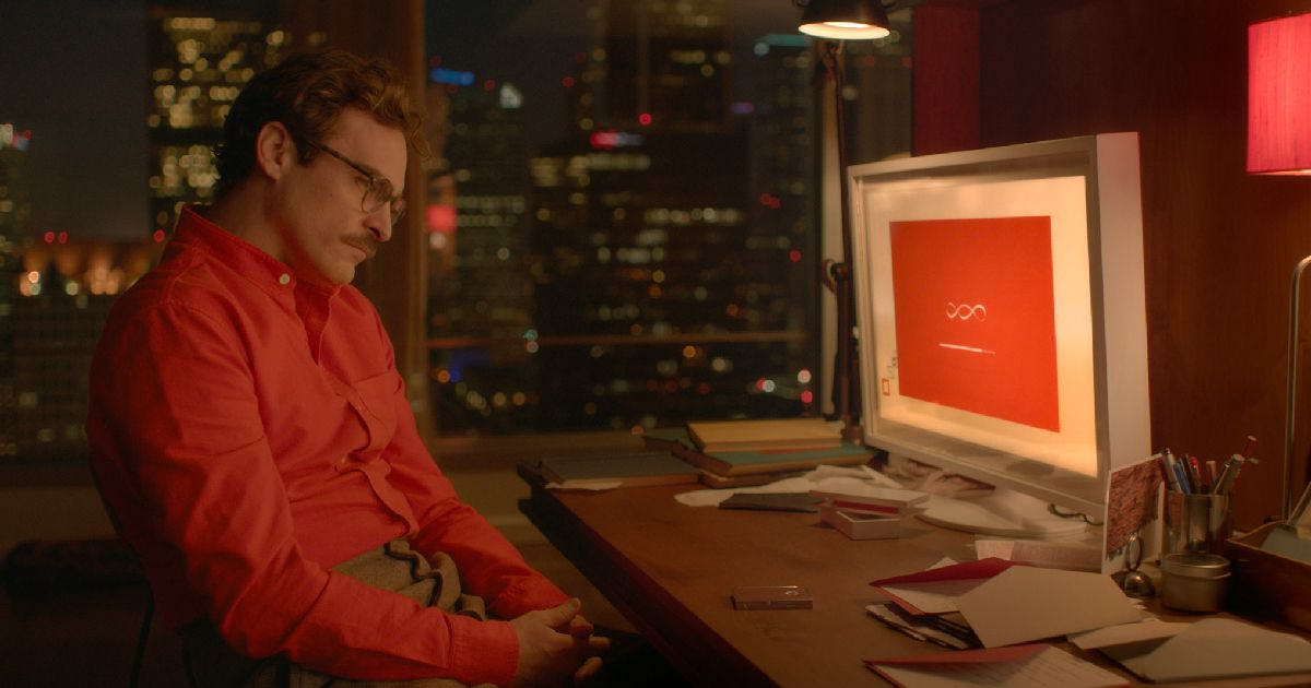 Joaquin Phoenix stares at a computer.