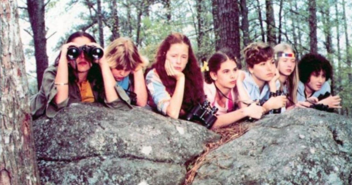 Girls lie on a rock with binoculars in Little Darlings