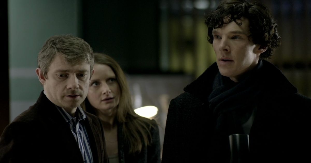 Martin Freeman as John, Louise Brealey as Molly, and Benedict Cumberbatch as Sherlock in a scene from Sherlock