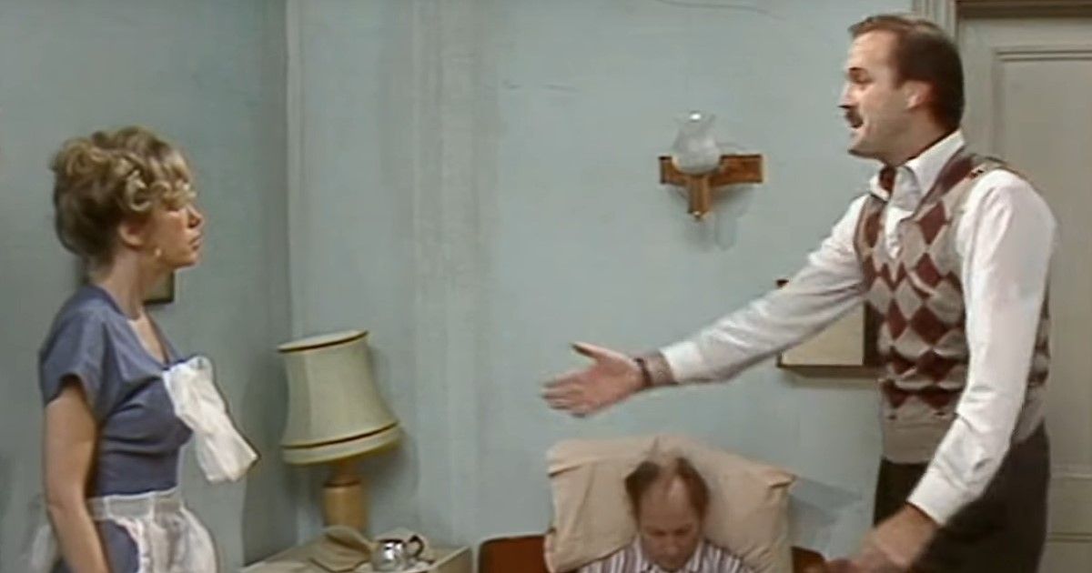 Basil, Polly, and the deceased man in a hotel room in Fawlty Towers