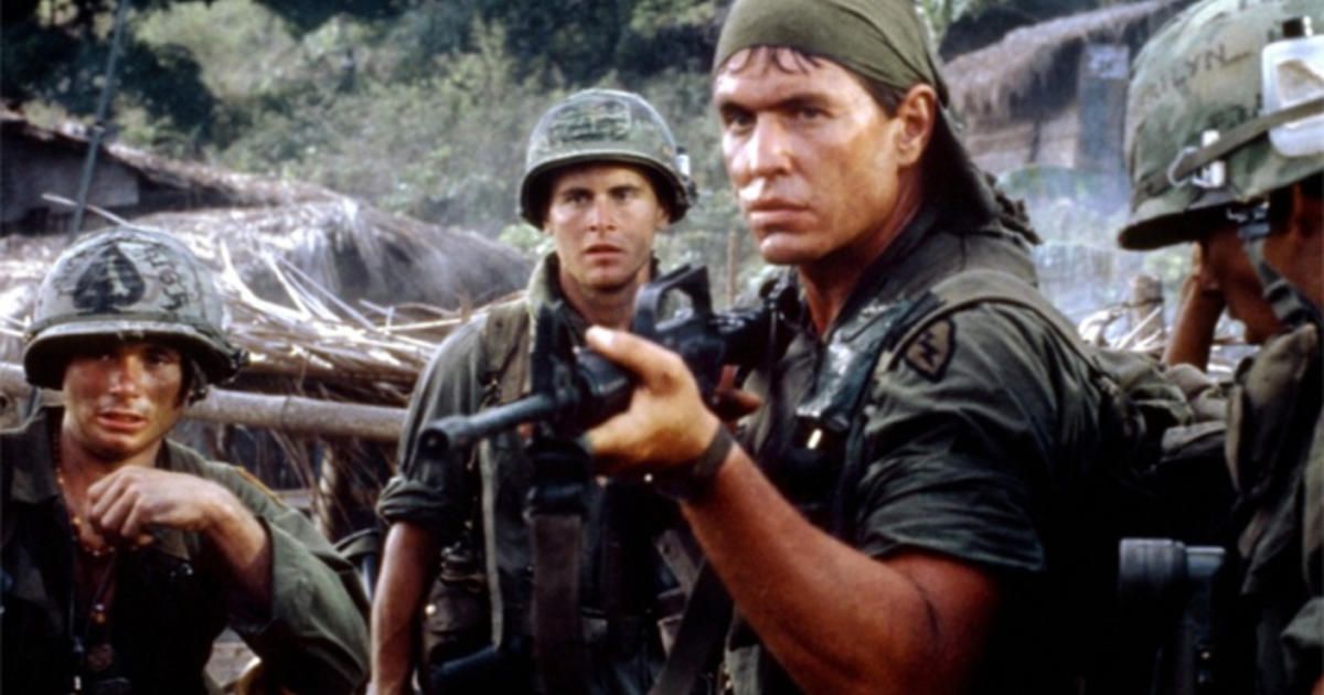 A group of soldiers, one aiming a gun, in Platoon