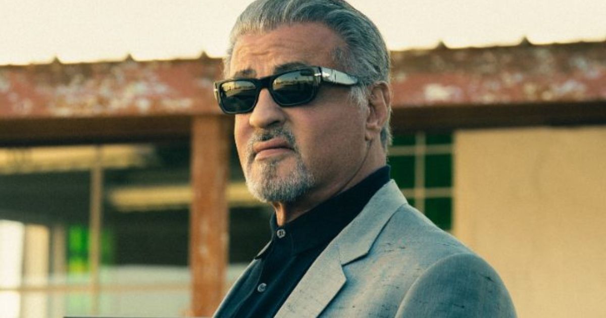 Sylvester Stallone wearing a suit and dark sunglasses in Tulsa King