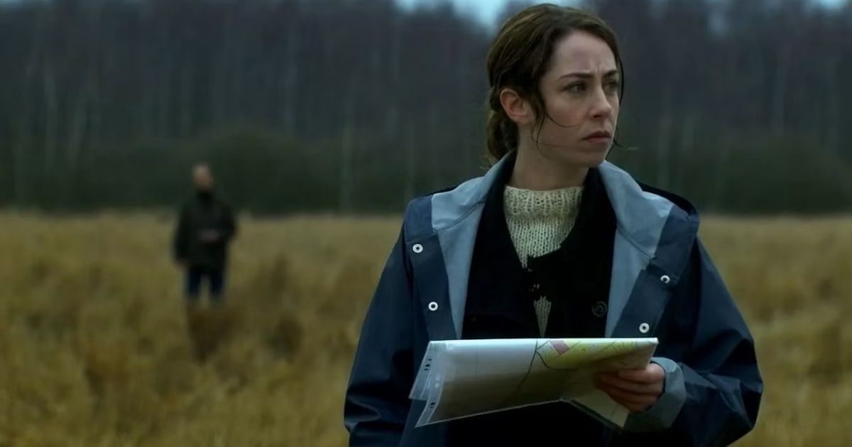 The detective stands in the field in The Killing