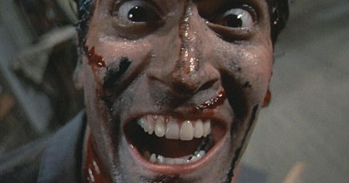 Bruce Campbell as Ash Williams laughing at the screen