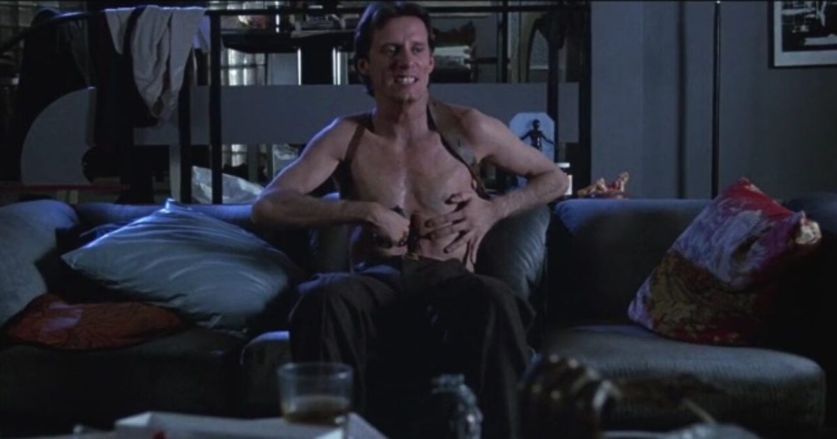 James Woods inserting his hand into his stomach