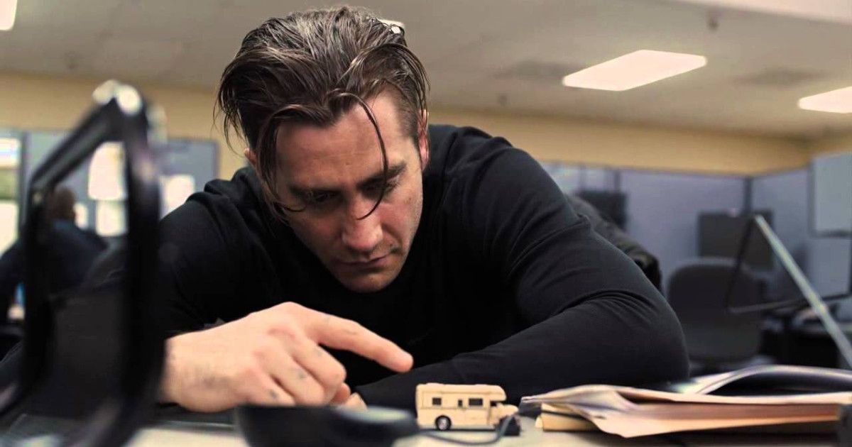 Jake Gyllenhaal with a miniature RV toy on his desk in the police station in Prisoners.
