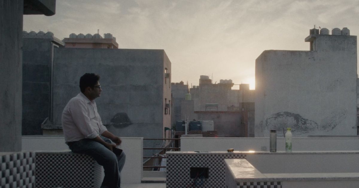Man sits on Delhi rooftop