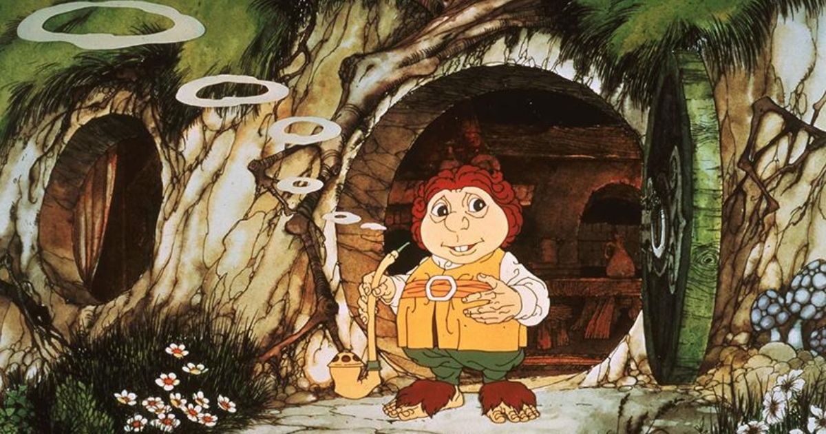 An animated Bilbo Baggins stands smoking a pipe outside of his hobbit hole
