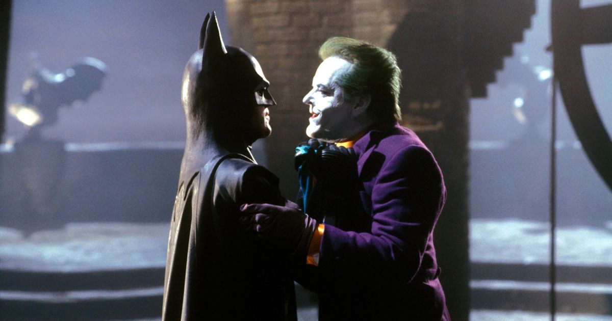Batman holding the Joker by the collar of his purple suit