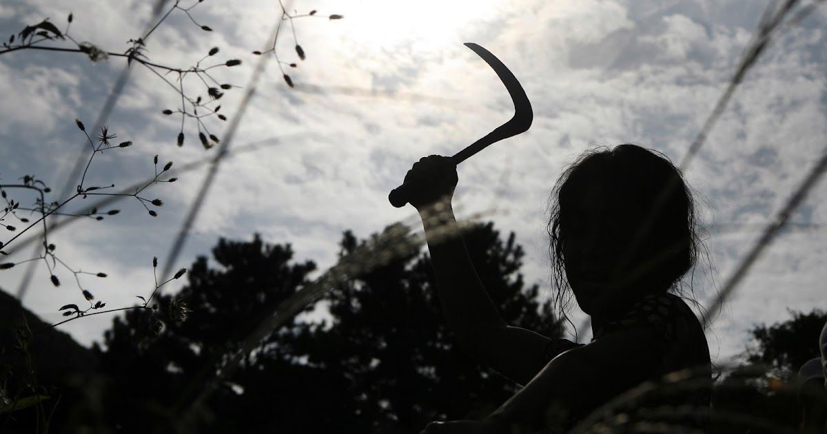A woman wields a scythe in Bedevilled