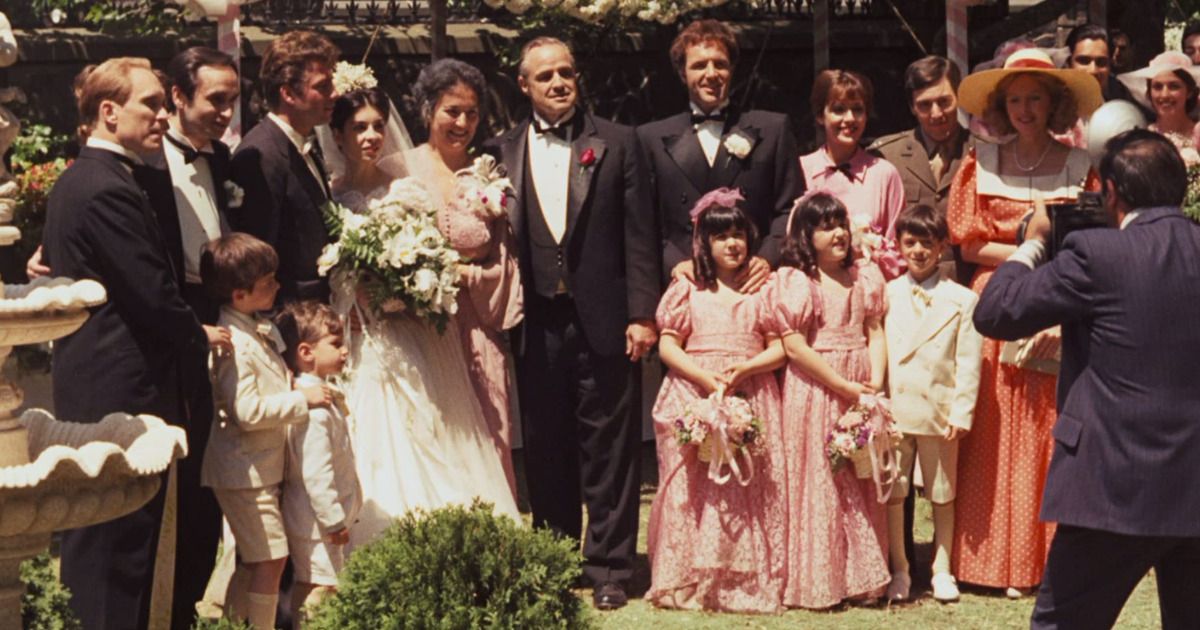 The corleone family taking a family photo at a wedding 