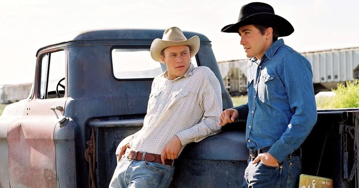 The Leads of Brokeback Mountain standing by a truck
