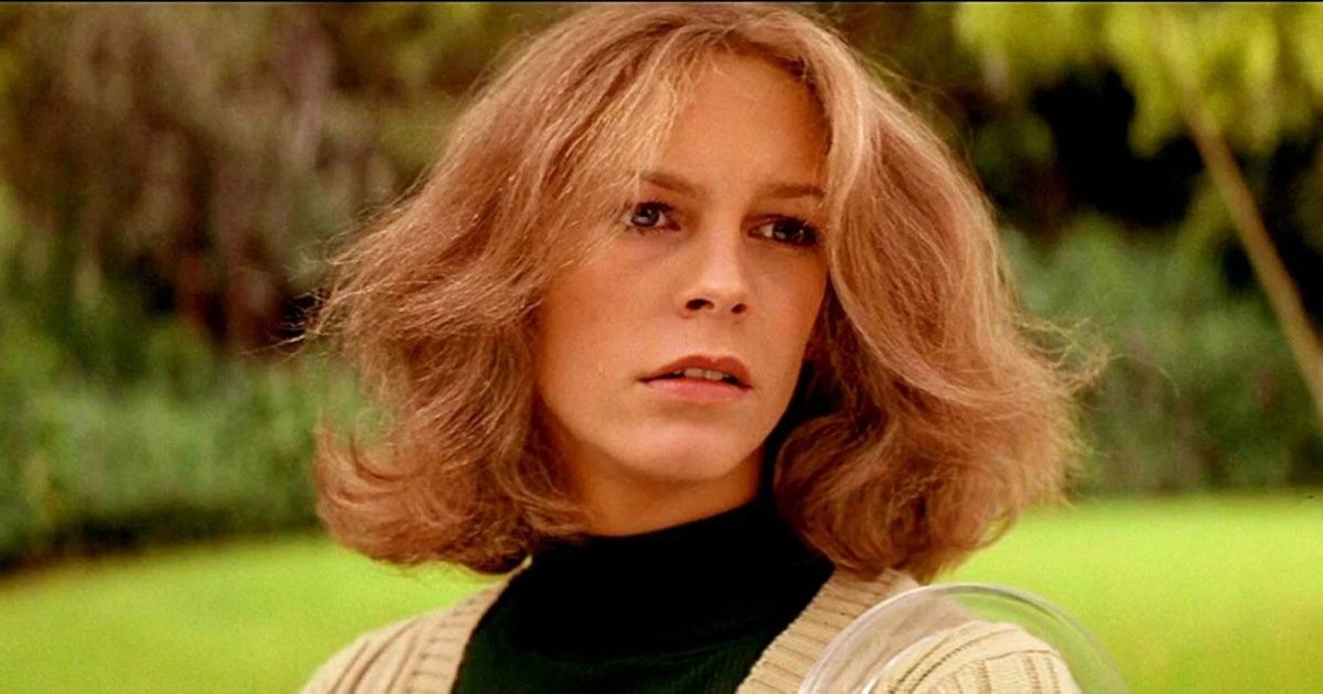 Jamie Lee Curtis as Laurie Strode wearing a black turtle neck and tan sweater on Halloween.