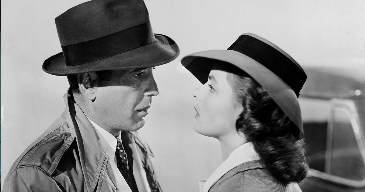 man and woman in hats looking longinly at each other