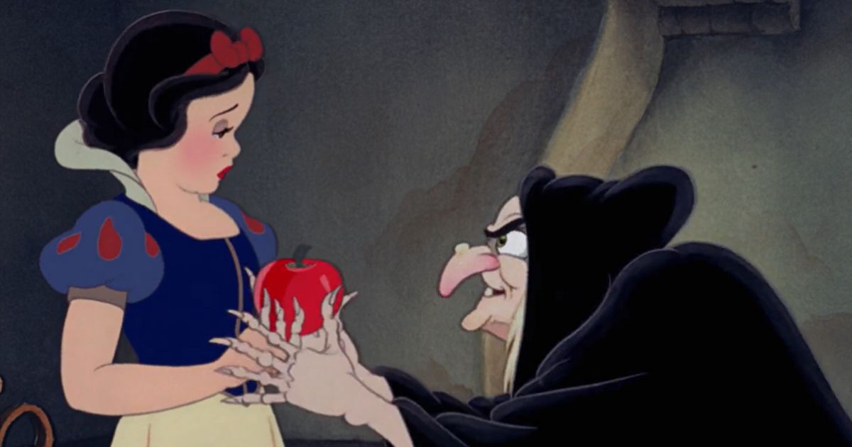 Snow White offered the poisoned apple from the Evil Queen in the old witch disguise