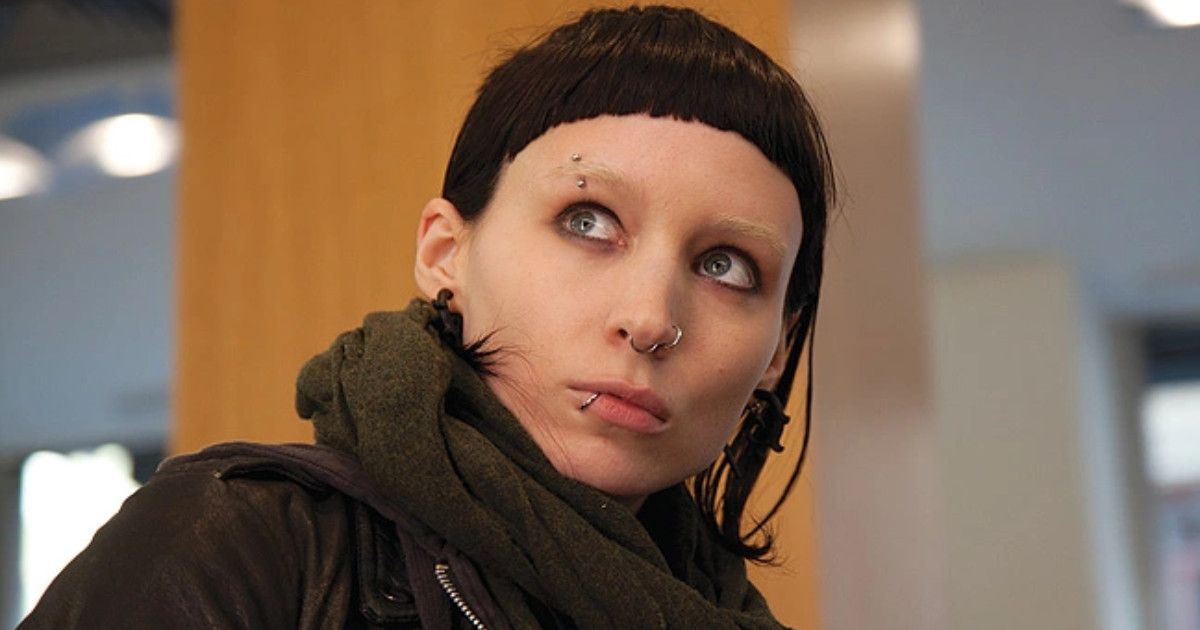 Rooney Mara as Lisbeth Salander with black hair wearing a scarf with piercings on her face in The Girl With the Dragon Tattoo