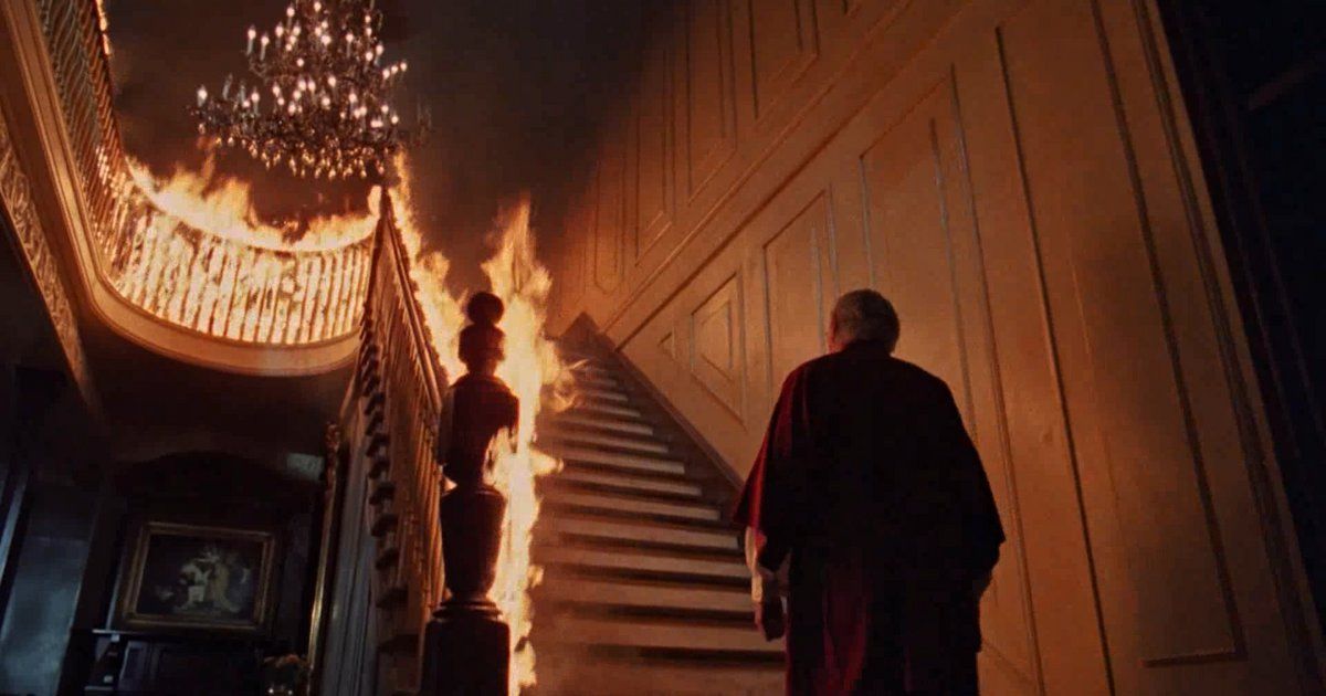 A man in front of a burning staircase in The Changeling