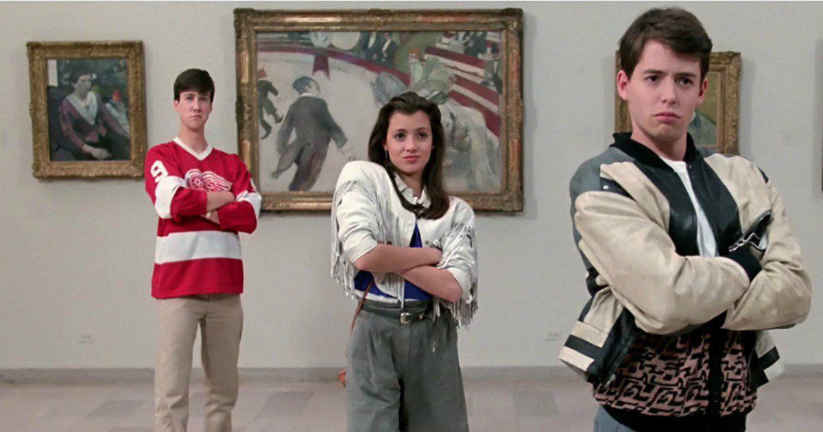three teenagers standing with their arms crossed in an art gallery