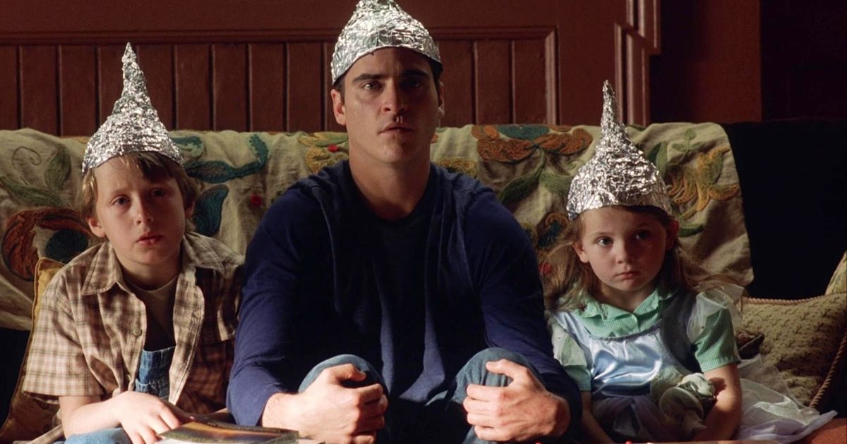 A man and two children wearing tinfoil hats