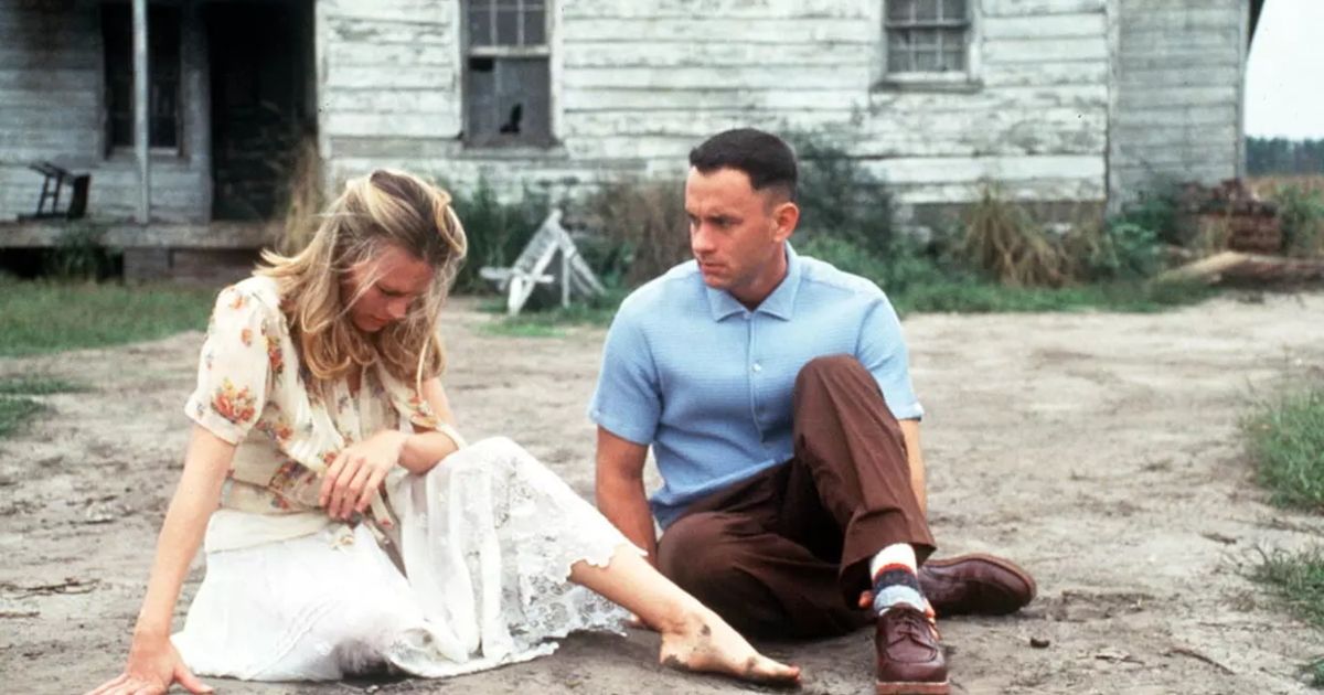 Forrest Gump and Jenny sit together on the ground in Forrest Gump.