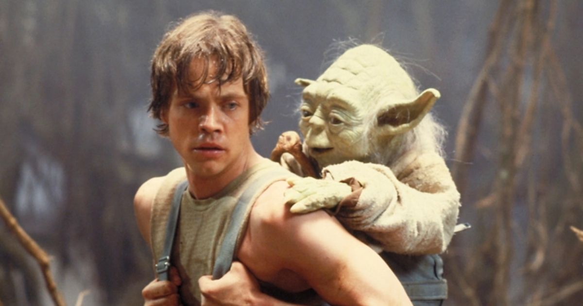 Luke Skywalker carries an old Yoda on his back.