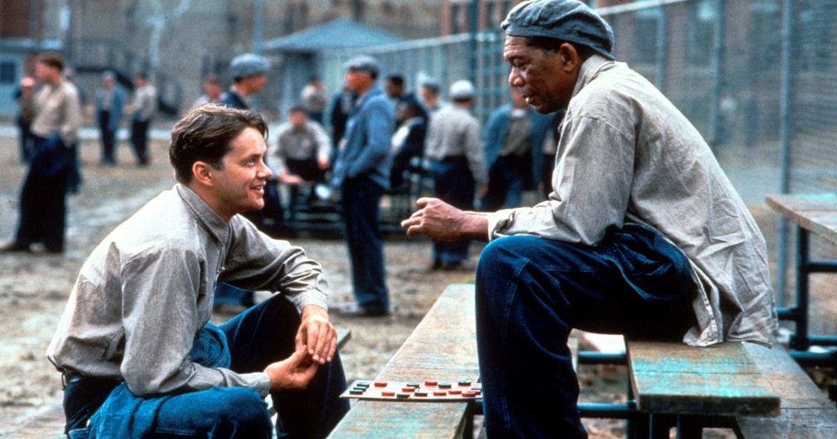 Tim Robbins as Andy and Morgan Freeman as Red sit in the Yard in The Shawshank Redemption.