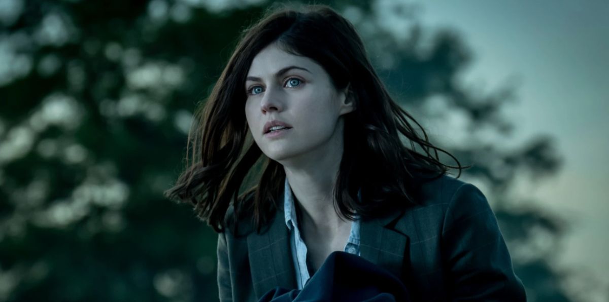 Alexandra Daddario, a white brunette women, in Mayfair Witches, looking distressed while wearing a suit with a typically buttoned shirt. 