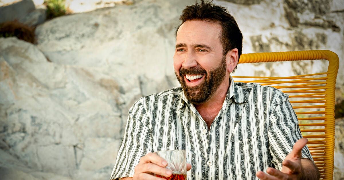 Nicolas Cage laughing with a drink Massive Talent photo