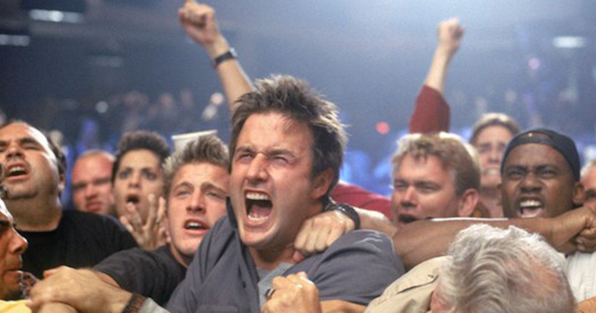 A man screaming in a crowd of people