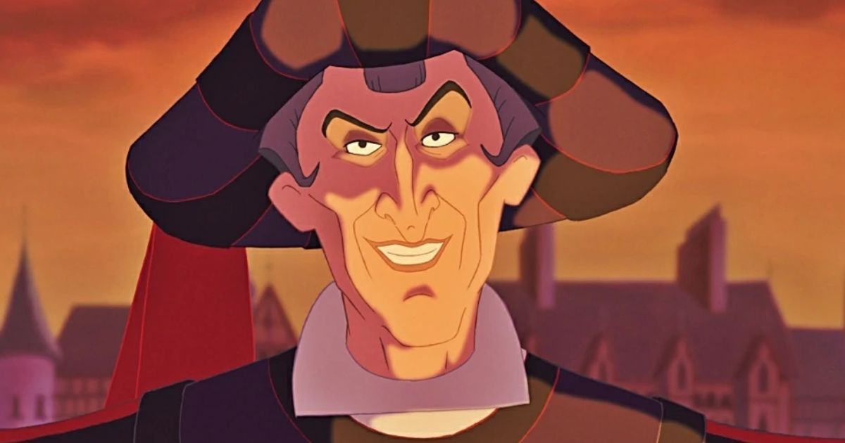 Judge Claude Frollo in The Hunchback Of Notre Dame wearing a large hat, grinning at the camera (1996)