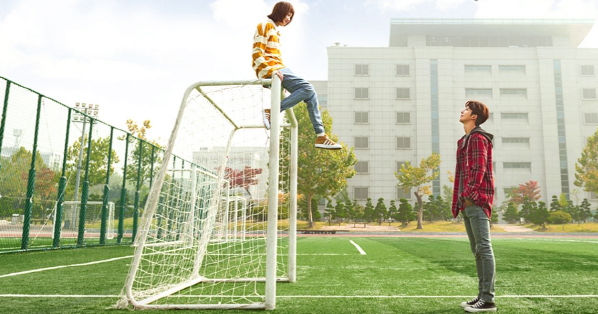 A character sitting on a goal post in Weightlifting Fairy Kim Bok Joo