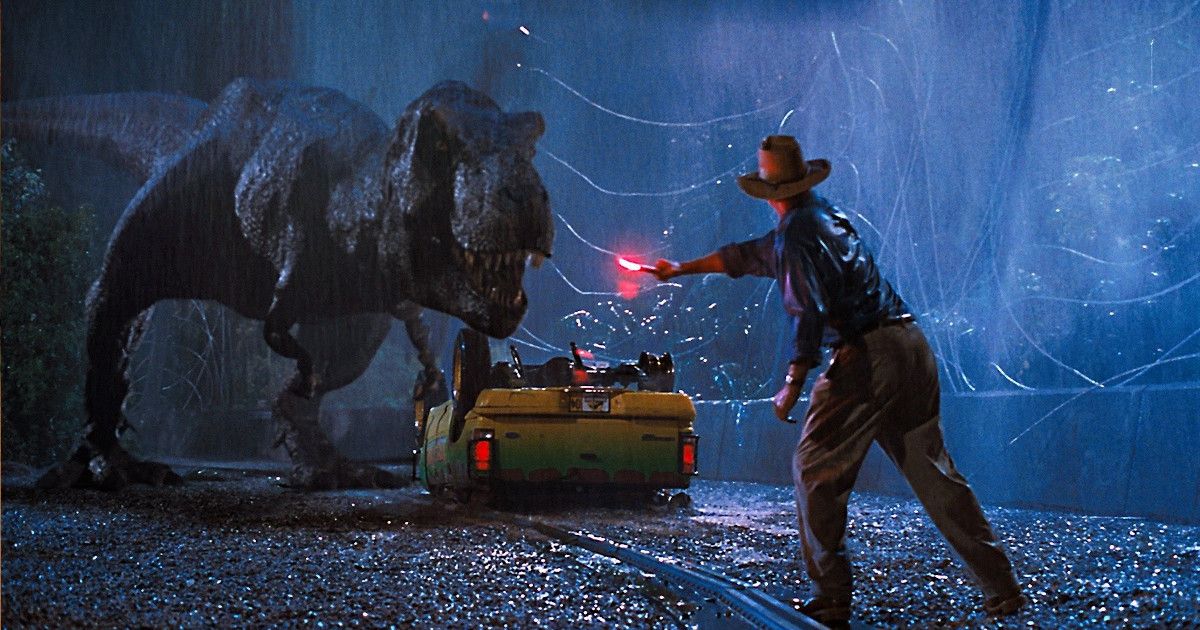 A man distracting a dinosaur with a flare.