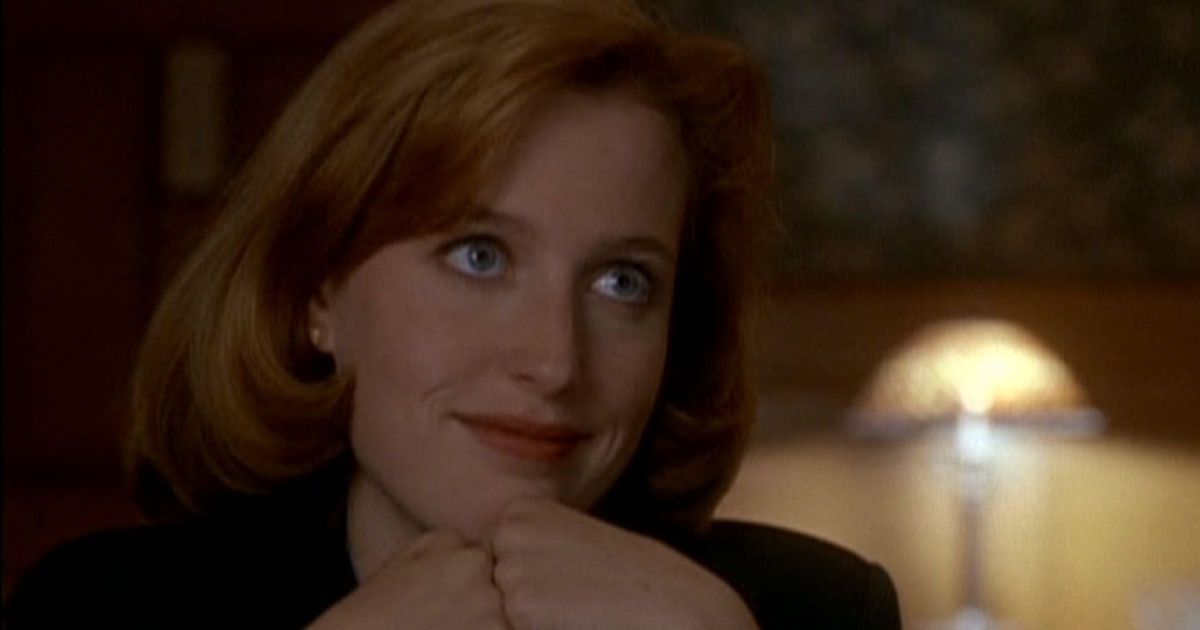 Agent Dana Scully with her hands under her chin
