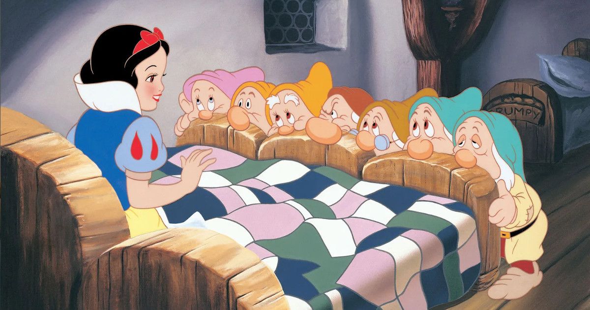 A woman in bed with seven dwarfs looking at her