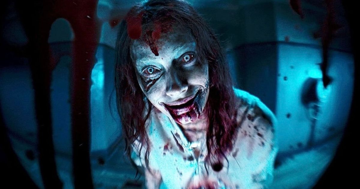 Ellie (Alyssa Sutherland) looking through a peephole in Evil Dead Rise (2023)