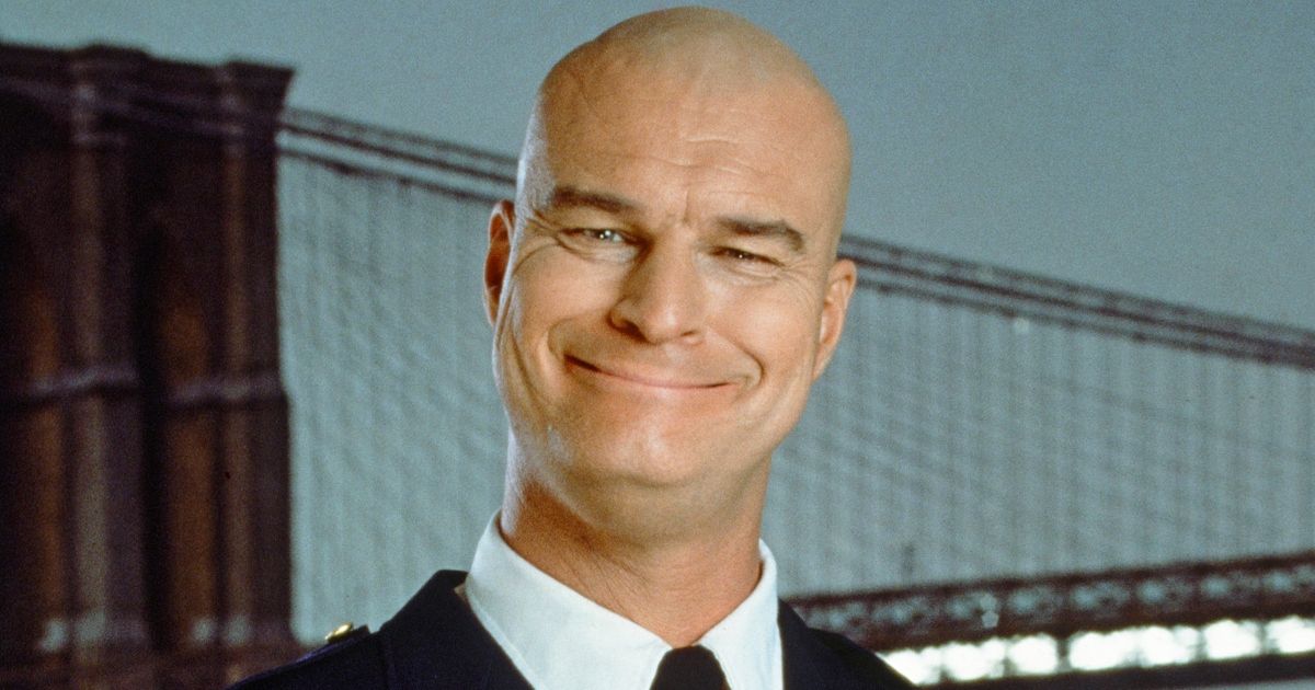 Richard Moll in Night Court with a bridge in the background.