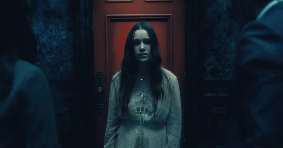 Woman Standing in Front of Red Door in The Haunting of Hill House