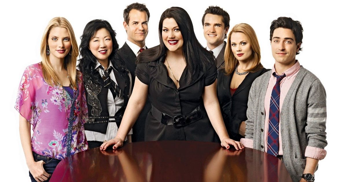 The cast of Drop Dead Diva poses around a table
