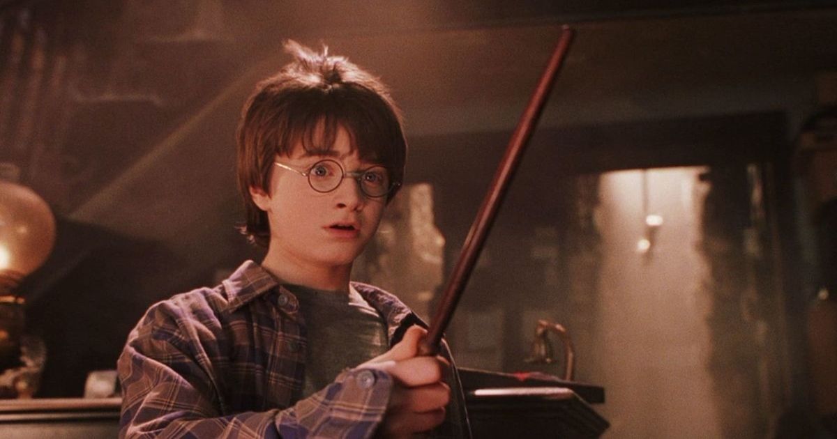 Harry Potter holding a wand in the first Harry Potter film.